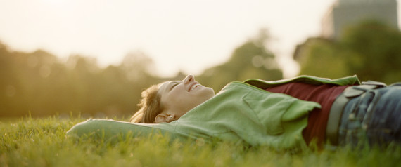 Girl lying in grass laughing